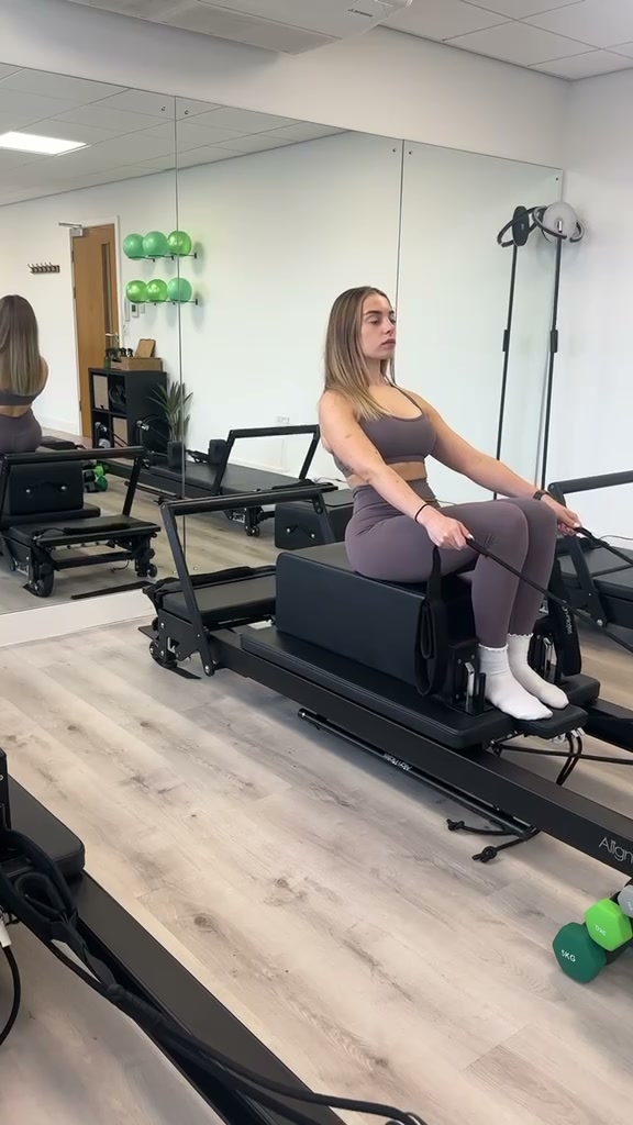 Practising technique on a reformer bed at PXY Reformer Pilates