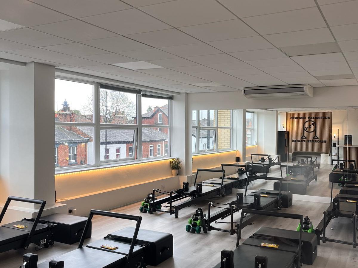 Sunlight streaming into the PXY Reformer Pilates studio with views over Didsbury rooftops
