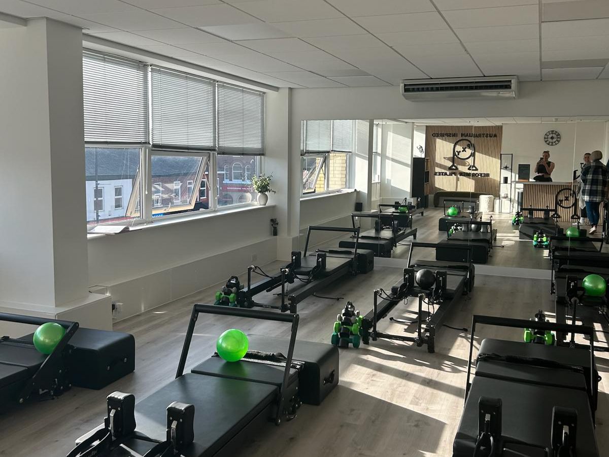 Reformer beds set up with balls and hand weights at PXY Reformer Pilates