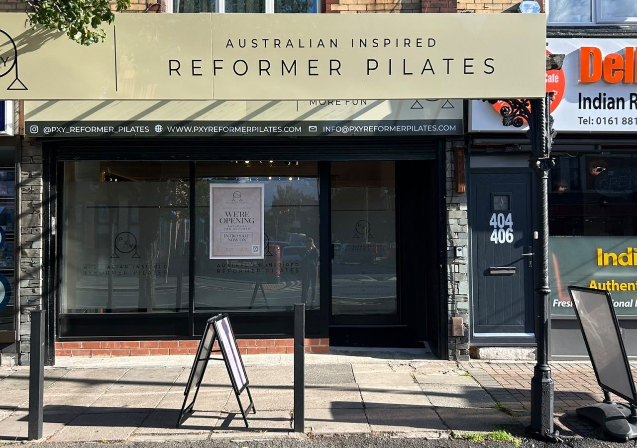 The PXY Reformer Pilates shopfront on Barlow Moor Road, Chorlton, with its sage Australian Inspired Reformer Pilates sign