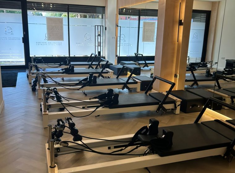Reformer beds lined up facing the frosted front windows of the Chorlton studio
